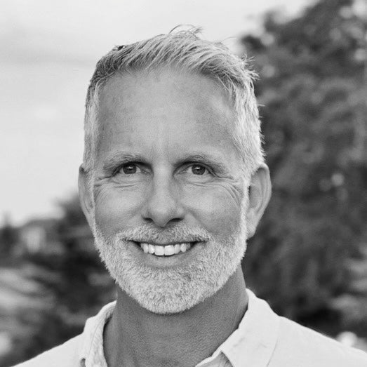 Black and white photo of a man with a beard and mustache outdoors
